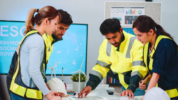 Engineers Discussing Wind Energy Project in Office.